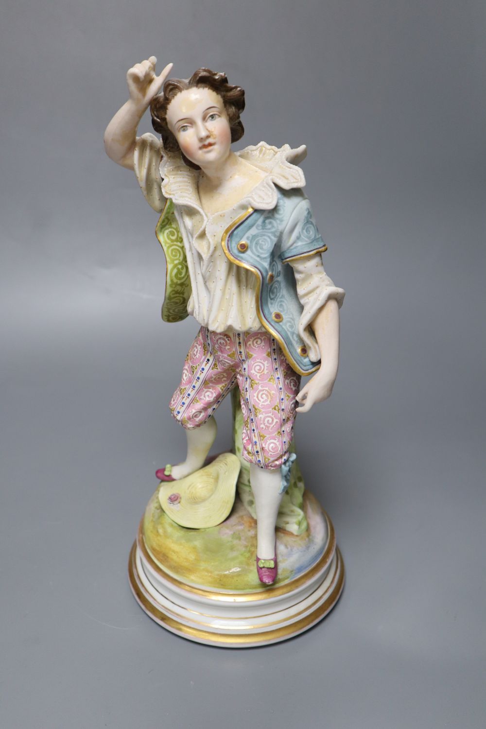 A 19th century French bisque figure, 32cm and two Vienna-style wall plates, 22cm